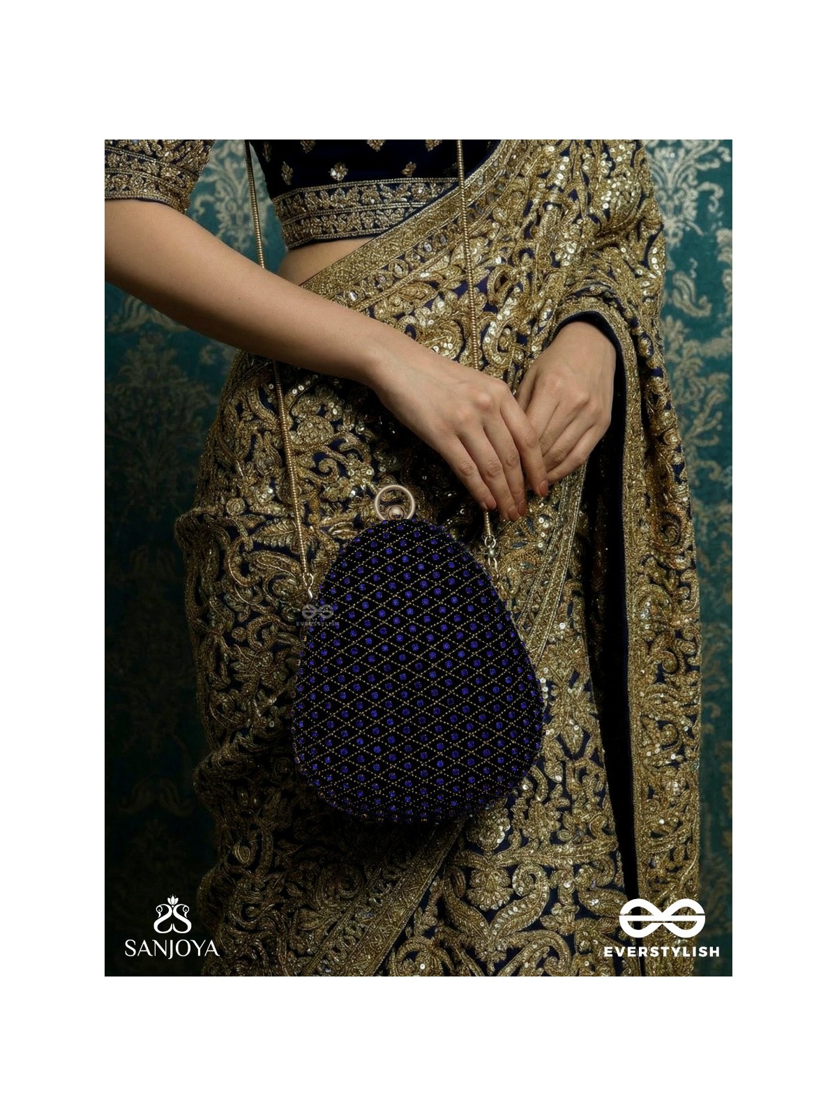SITARAA – POLISHED OVAL ROYAL BLUE VELVET CLUTCH WITH STONE-ACCENTED HANDWORK AND GOLDEN METAL FRAME