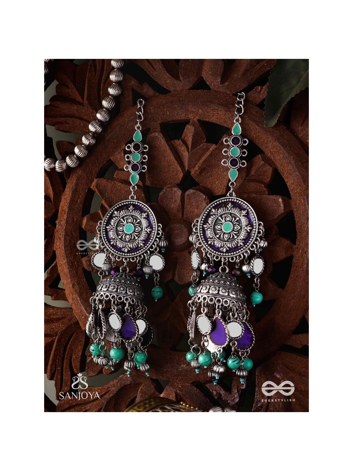 RATNA TILAKA-JEWEL ADORNMENT- EARRINGS ENAMELLED IN SHADES OF BLUE AND BLACK, ACCENTED WITH GHUNGROO BEADS AND OXIDIZED JHUMKI