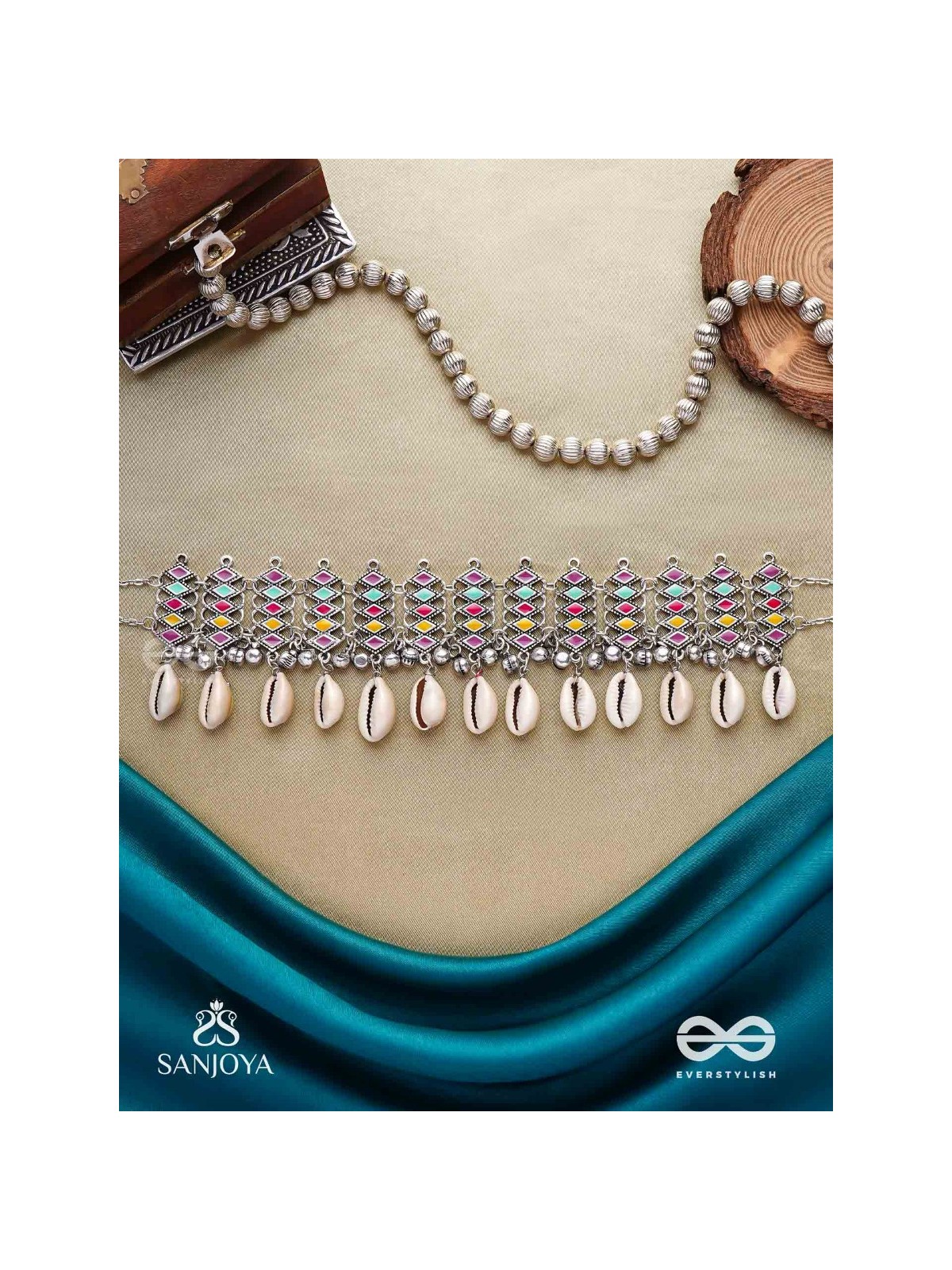 SHANKHAMALA-CONCH GARLAND- OXIDIZED NECKPIECE FEATURING PASTEL-COLOURED METALWORK, EMBELLISHED WITH DANGLING COWRIE SHELLS AND GHUNGROO'S
