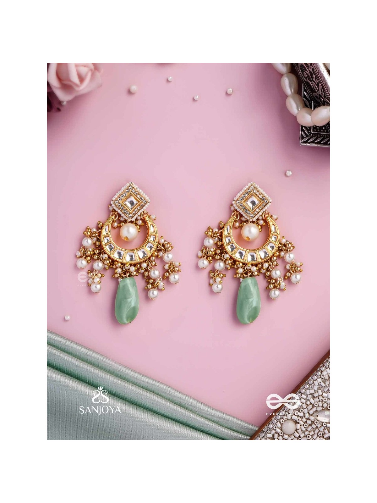 PURNIMA PHOOL – FULL MOON FLOWER AN EXQUISITE KUNDAN EARRING FEATURING GOLDEN DESIGNS, PEARL CLUSTERS, AND A GREEN GEMSTONE DROP, SYMBOLIZING ELEGANCE