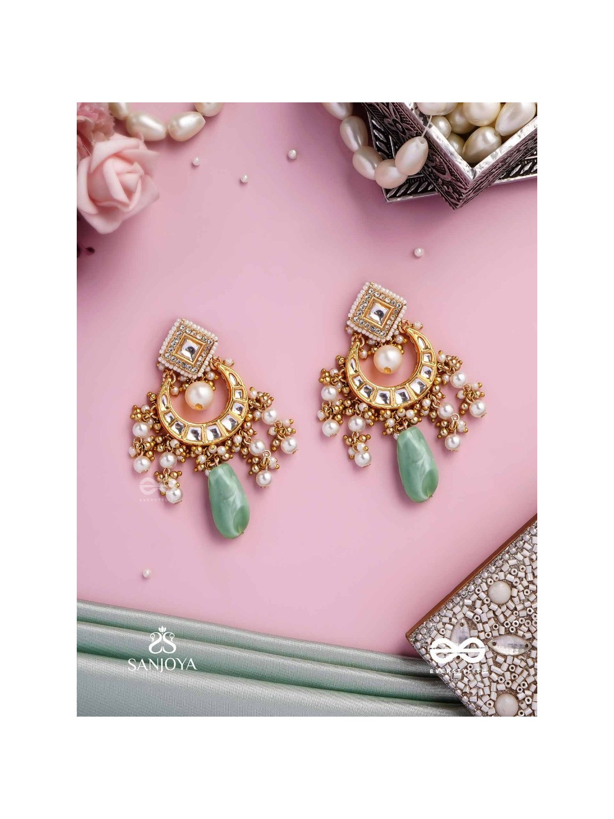 PURNIMA PHOOL – FULL MOON FLOWER AN EXQUISITE KUNDAN EARRING FEATURING GOLDEN DESIGNS, PEARL CLUSTERS, AND A GREEN GEMSTONE DROP, SYMBOLIZING ELEGANCE