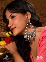 CHANDRAMAYURA- MOON-PEACOCK EARRINGS- OXIDIZED CHAANDBAALI EARRINGS, ADORNED WITH MIRRORS, GHUNGHROOS, COWRIE SHELLS, AND DANGLING JHUMKA