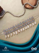 SHANKHAMALA-CONCH GARLAND- OXIDIZED NECKPIECE FEATURING PASTEL-COLOURED METALWORK, EMBELLISHED WITH DANGLING COWRIE SHELLS AND GHUNGROO'S