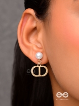 Starlit orb- dangling pearl earrings with golden spheres 