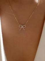 TIED IN GOLD- MINIMALIST BOW NECKPIECE